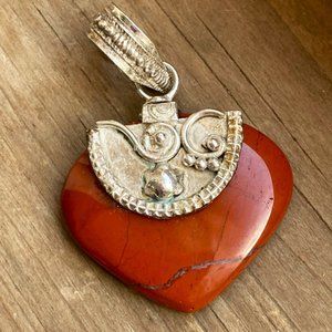 Deep red jasper pendant set in detailed sterling silver